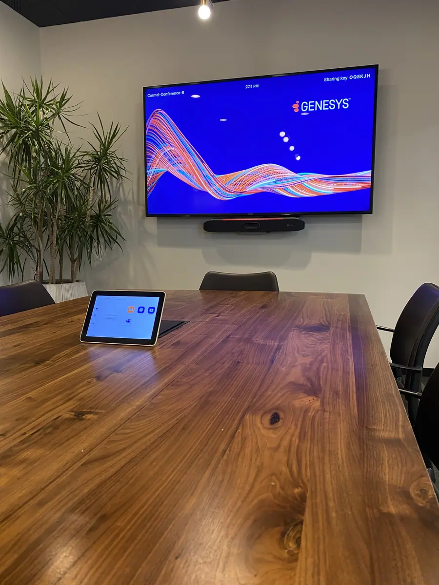 Boardroom with wall display and touch controller installed by River Systems