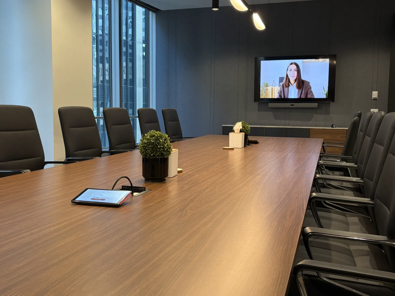 Boardroom video conference with a presenter on the display
